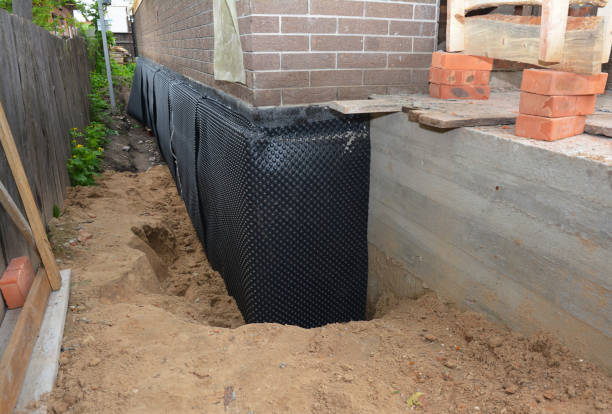 Happy homeowners after waterproofing job in Montezuma